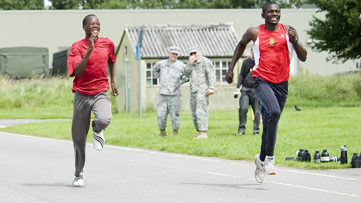 Two distance runners racing toward a finish line